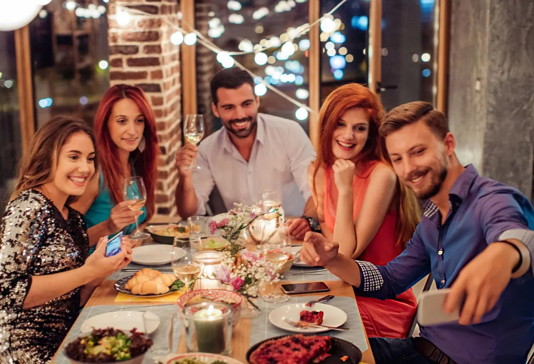 Friends sharing a meal and taking a photo together